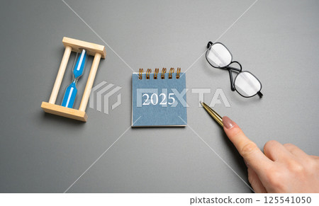 Paper calendar 2025 and hourglass Beginning of a new year. Plan, planning and achieving goals. Copy space Paper calendar 2025 and hourglass Beginning of a new year. Plan, planning and achieving goals. Copy space 125541050