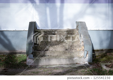 Cracked Concrete Staircase with Deteriorating Steps 125541150