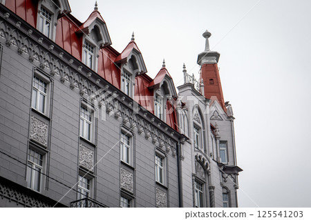 Ornate Building Roof with Red Tiles and Decorative Architectural Elements 125541203