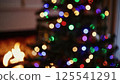 Vibrant christmas lights bokeh soft focus glowing multicolor circles blurred fireplace background festive party atmosphere abstract holiday pattern shimmer 125541291