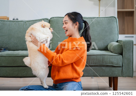 Lifestyle People, Happy woman spending holiday with her dog, companionship, and relaxation. 125542601