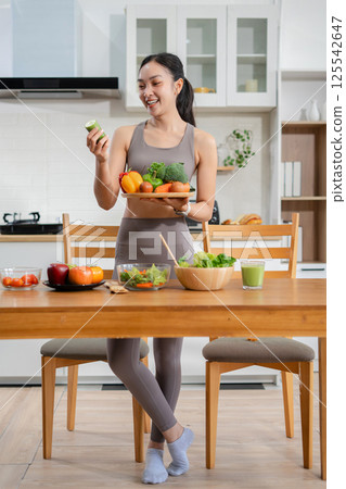 Fit woman enjoys healthy fruit breakfast after yoga training. fitness, nutrition, healthy lifestyle. Fit woman enjoys healthy fruit breakfast after yoga training. fitness, nutrition, healthy lifestyle. 125542647