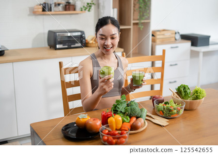 Fit woman enjoys healthy fruit breakfast after yoga training. fitness, nutrition, healthy lifestyle. 125542655