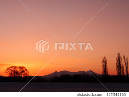 Sunrise and snowy mountains Sunrise and snowy mountains 125543163