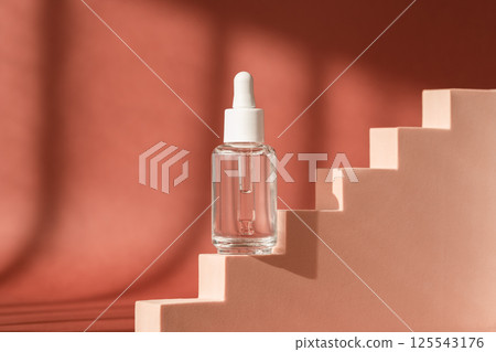 Serum skincare glass bottle, hyaluronic acid on brown podium pedestal, art deco. Serum product cosmetic with peptide and collagen. Modern brand cosmetics packaging. Cosmetic showcase Serum skincare glass bottle, hyaluronic acid on brown podium pedestal, art deco. Serum product cosmetic with peptide and collagen. Modern brand cosmetics packaging. Cosmetic showcase 125543176