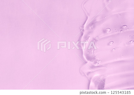 Cosmetic cream transparent purple liquid gel sample swatch. Hyaluronic acid for skin care with collagen and retinol. Pink gel smudge isolated on purple background 125543185