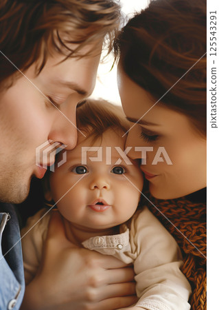 Happy couple kissing newborn baby, showing affection to infant child 125543291