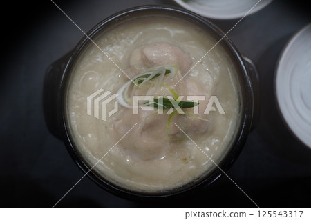 Samgyetang is a Korean soup of chicken stuffed with rice and ginseng, served in a hot broth 125543317