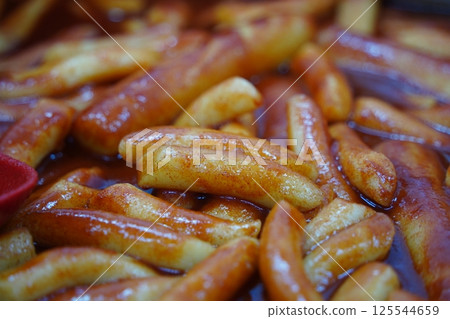Tteokbokki is a popular Korean dish of chewy rice cakes cooked in a sweet and spicy gochujang sauce. 125544659