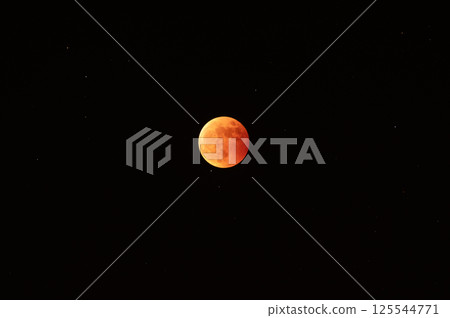 A red moon floating in the sky during a total lunar eclipse A red moon floating in the sky during a total lunar eclipse 125544771