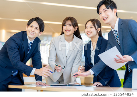 Young businessmen having a meeting. Photo courtesy of Denpa Gakuen, Tokyo Electronics College. 125544924