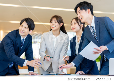 Young businessmen having a meeting. Photo courtesy of Denpa Gakuen, Tokyo Electronics College. 125544925