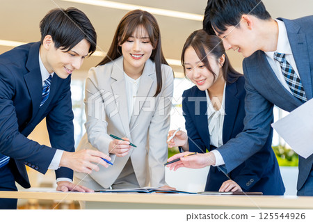 Young businessmen having a meeting. Photo courtesy of Denpa Gakuen, Tokyo Electronics College. 125544926