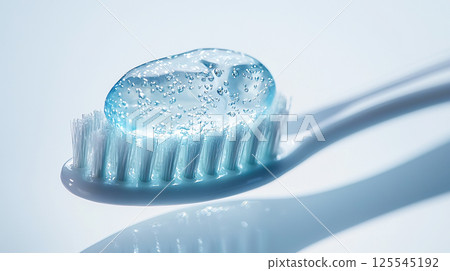 Close-up of clear gel toothpaste on the tip of a toothbrush 125545192