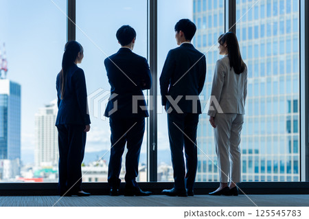 Businessmen in an office building. Photo courtesy of Denpa Gakuen, Tokyo Electronics College. 125545783