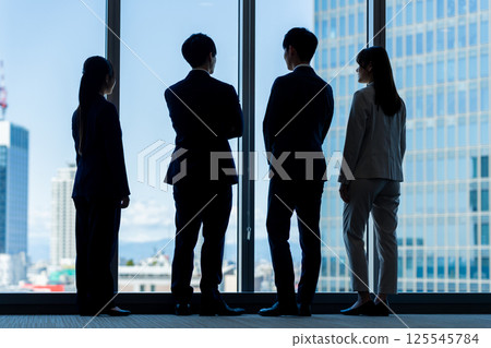 Businessmen in an office building. Photo courtesy of Denpa Gakuen, Tokyo Electronics College. 125545784