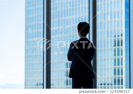 Businessmen working in an office building. Photo courtesy of Denpa Gakuen, Tokyo Electronics College. 125546157