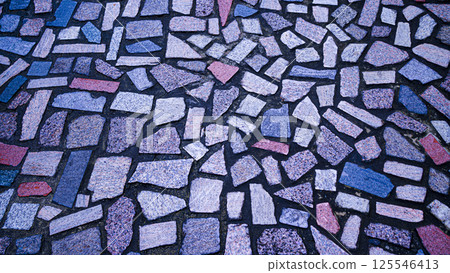 Small ceramic tiles embedded in cement. 125546413
