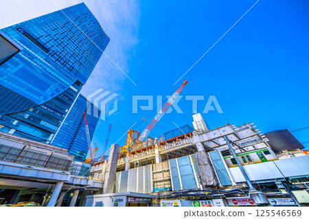 Tokyo cityscape in Japan: A view of a crane facing right, the redevelopment of Shibuya Station, and the new Hachiko ticket gate at the bottom of Miyamasuzaka. (21st) 125546569