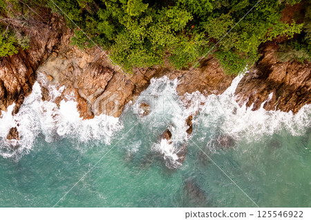 Top view seashore waves nature background,Amazing waves crashing on rocks seascape view 125546922