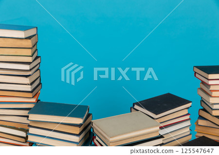 Stacks of books on the blue background of the university library 125547647