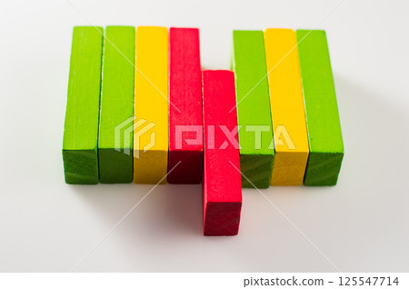 The photo shows a set of colorful wooden blocks resembling construction parts. These motor skill toys help develop hand coordination. The photo shows a set of colorful wooden blocks resembling construction parts. These motor skill toys help develop hand coordination. 125547714