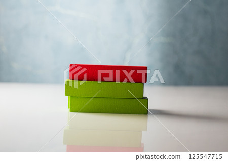 The photo shows a set of colorful wooden blocks resembling construction parts. These motor skill toys help develop hand coordination. 125547715