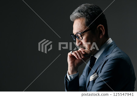 Businessman thinking sideways Businessman thinking sideways 125547941