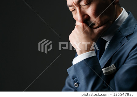 Businessman thinking sideways Businessman thinking sideways 125547953