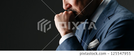Businessman thinking sideways Businessman thinking sideways 125547955