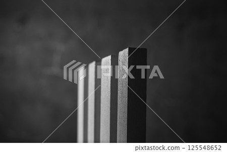 Children's developmental blocks in black and white photo. Small wooden blocks are arranged like a bright mosaic. Developmental wooden sticks teach logic and creativity. Children's developmental blocks in black and white photo. Small wooden blocks are arranged like a bright mosaic. Developmental wooden sticks teach logic and creativity. 125548652