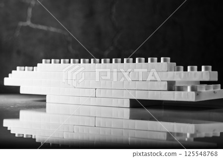 The children's plastic construction set. The placement of the parts appears random but sparks interest.  125548768