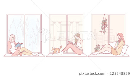 Cozy Moments Enjoying Reading and Relaxation by the Window with a Perfect Ambiance Cozy Moments Enjoying Reading and Relaxation by the Window with a Perfect Ambiance 125548839