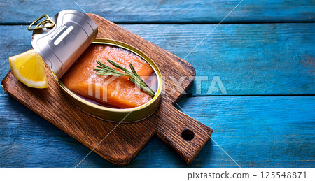 Close-up of a Salmon Fish Fillet in an Open Can on a Wooden Table - Generative Ai 125548871