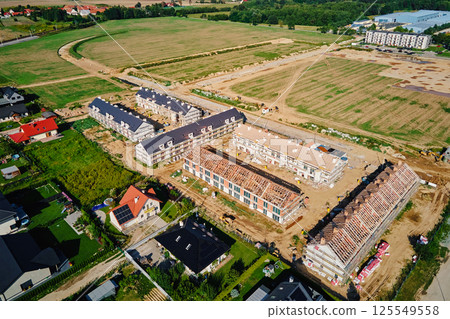 Construction site of new modern housing complex in suburban area Construction site of new modern housing complex in suburban area 125549558