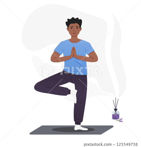 Young man performs a yoga balance pose while meditating peacefully. 125549738