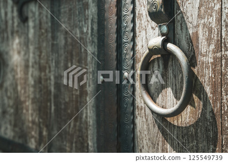 Old barn wooden door with iron ring. Lock door background Old barn wooden door with iron ring. Lock door background 125549739