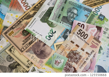 Big amount of money bills of different currencies and countries. Assortment background of international cash in big pile close up Big amount of money bills of different currencies and countries. Assortment background of international cash in big pile close up 125550668