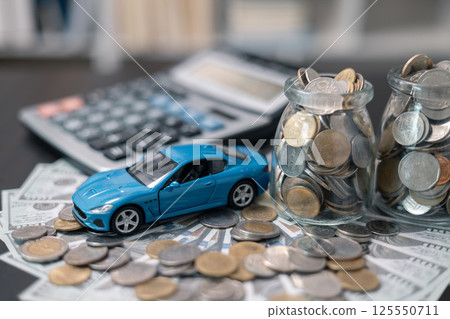 Business concept involved using finance calculator to determine premium for vehicle policy, ensuring clear financial contract for car. Investing in auto insurance can save money on transport costs. Business concept involved using finance calculator to determine premium for vehicle policy, ensuring clear financial contract for car. Investing in auto insurance can save money on transport costs. 125550711
