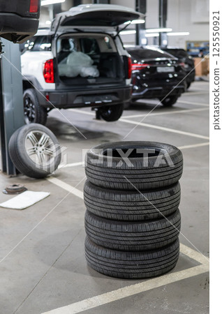 Changing tires for a car according to the season.  125550921