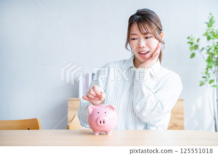 A woman saving money A woman saving money 125551018