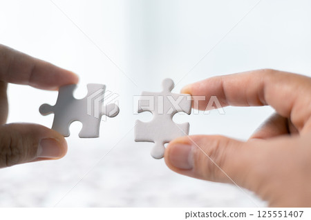 Team with piece of jigsaw puzzle as critical component of business strategy, understanding teamwork and collaboration were essential for achieving success and realizing concept of well-executed plan. 125551407
