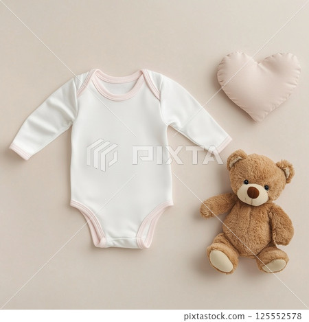 Baby romper on beige background Baby romper on beige background 125552578