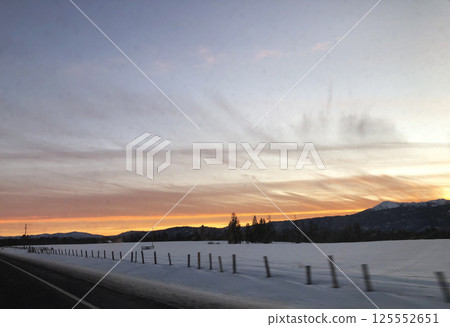 Sunset on the road from Brundage Mountain ski resort. View from car. Sunset on the road from Brundage Mountain ski resort. View from car. 125552651