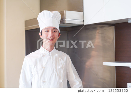 A male chef wearing a chef's hat A male chef wearing a chef's hat 125553560