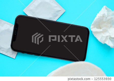Mockup for adult content website or app on smartphone display with porn watching attributes for masturbation. Copy space 125553930
