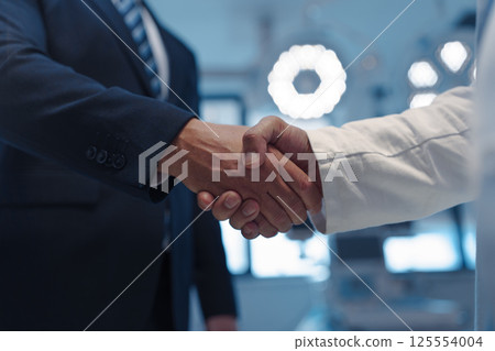 Hospital business handshake in medical environment 125554004