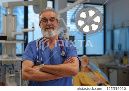 Portrait of doctor standing in examination room in hospital. Portrait of doctor standing in examination room in hospital. 125554010
