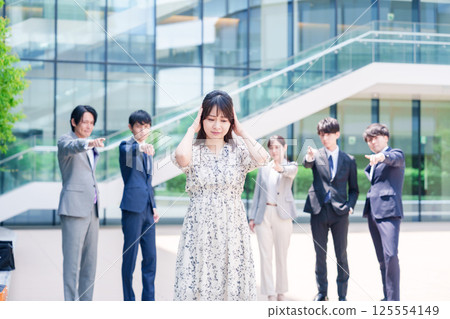 A female business person holding her head after being blamed by a colleague A female business person holding her head after being blamed by a colleague 125554149