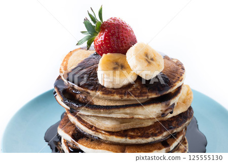 Pancakes with chocolate and fruit isolated on white background Pancakes with chocolate and fruit isolated on white background 125555130